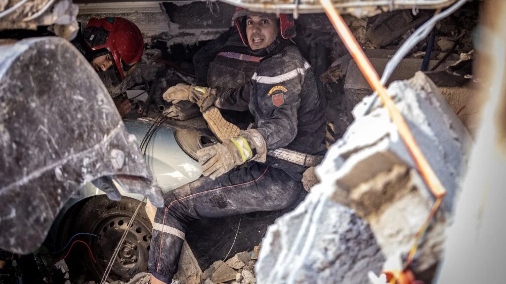 Rescue workers search for survivors in a collapsed house in Moulay Brahim, al-Haouz province, on 9 September 2023, after Morocco was struck by its deadliest earthquake in decades (AFP)