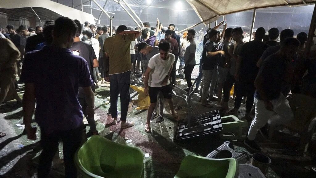 Resident look at the damage caused by a gas tanker explosion in Baghdad on 29 October 2022, near a cafe and stadium (AFP)