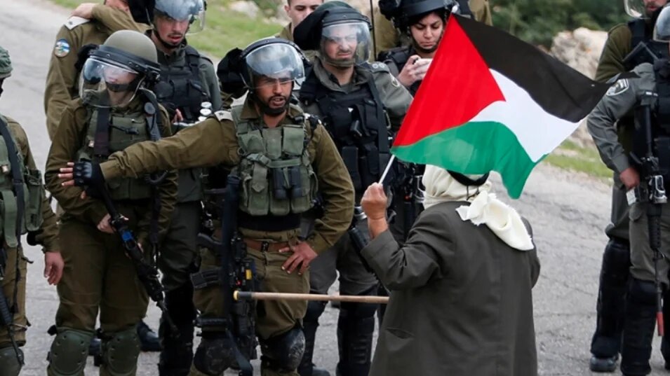 A Palestinian protests against Israeli settlements 