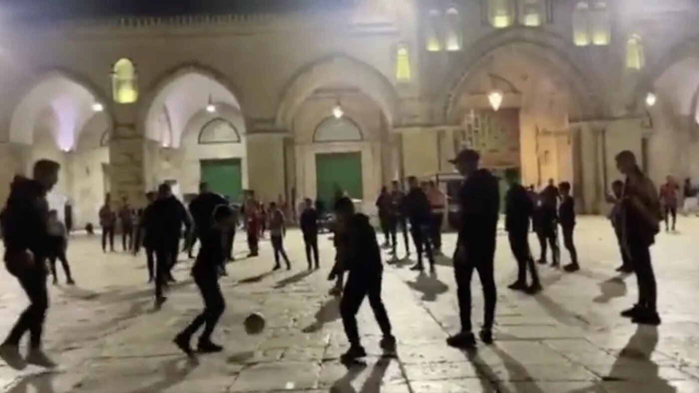 Palestinian teens play soccer outside Al-Aqsa Mosque (Screenshot from social media) 
