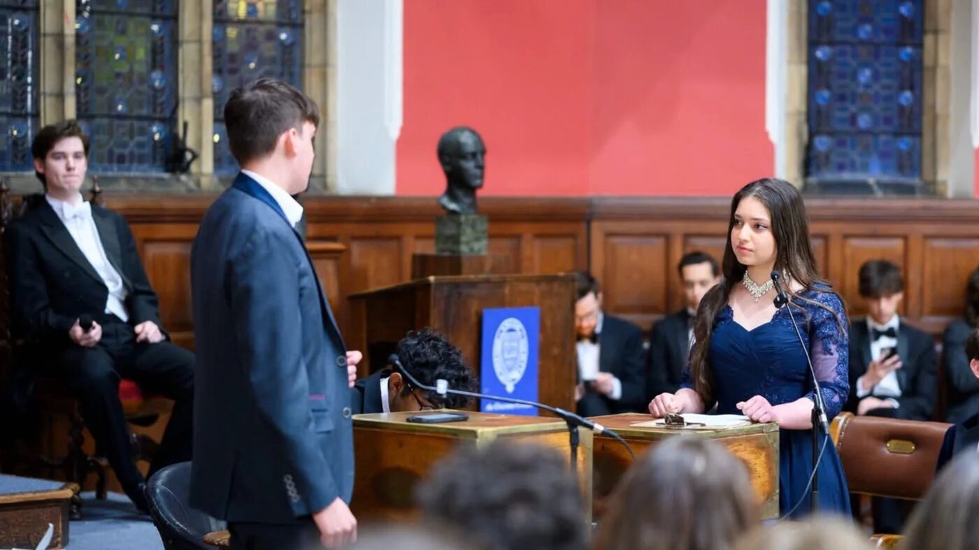 Oxford Union President Arwa Elrayess (R) speaks in the union chamber in early June 2026. (Arwa Elrayess)