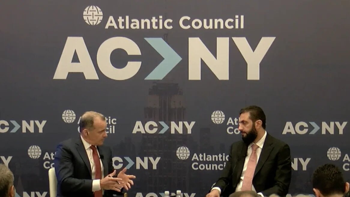 Former US diplomat Brett McGurk, left, speaks to Syrian President Ahmed al-Sharaa at an event hosted by the Atlantic Council in New York City on 22 September 2026 (Screengrab/YouTube)