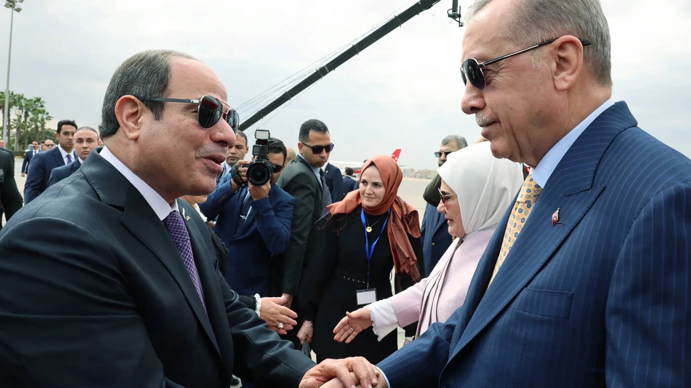 Egypt's President Abdel Fattah el-Sisi (L) greets Turkey’s President Recep Tayyip Erdogan at Cairo airport, 14 February 2024 (Turkish Presidential Press Office/HO via Reuters)