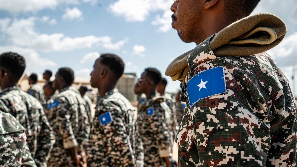 A Somali soldier stands at attention at the General Dhagabadan Training Centre in Mogadishu on 19 March 2024 (Amaury Falt-Brown/AFP)