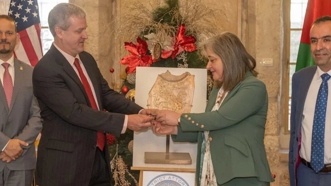 George Noll, chef du Bureau américain des affaires palestiniennes, restitue une cuillère en ivoire pillée à la ministre du Tourisme et des Antiquités de l’Autorité palestinienne, Rula Maayah, à Bethléem, le 5 janvier 2022 (Twitter/Bureau américain des affaires palestiniennes)