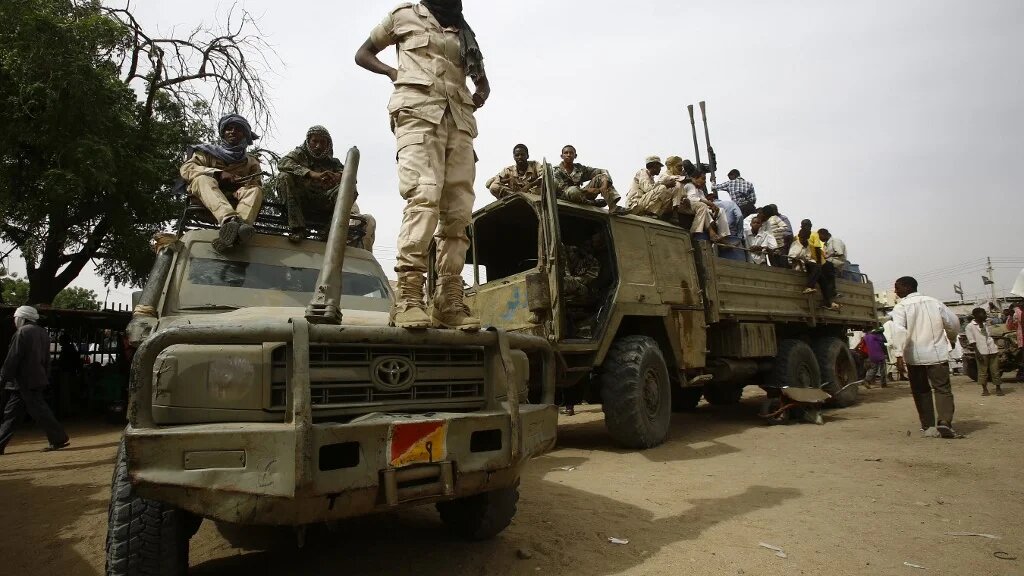 Fighters from the Sudanese Rapid Support Forces sit in vehicles in the city of Nyala, in south Darfur, on 3 May 2015 (Ashraf Shazly/AFP)