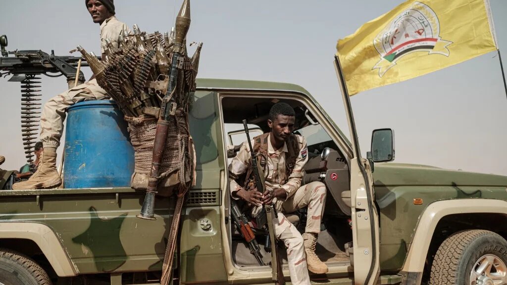 Members of the RSF paramilitaries secure the place for a rally for supporters of Sudan's ruling Transitional Military Council (TMC) in the village of Abraq, in June 2019 (Yasuyoshi Chiba/AFP)