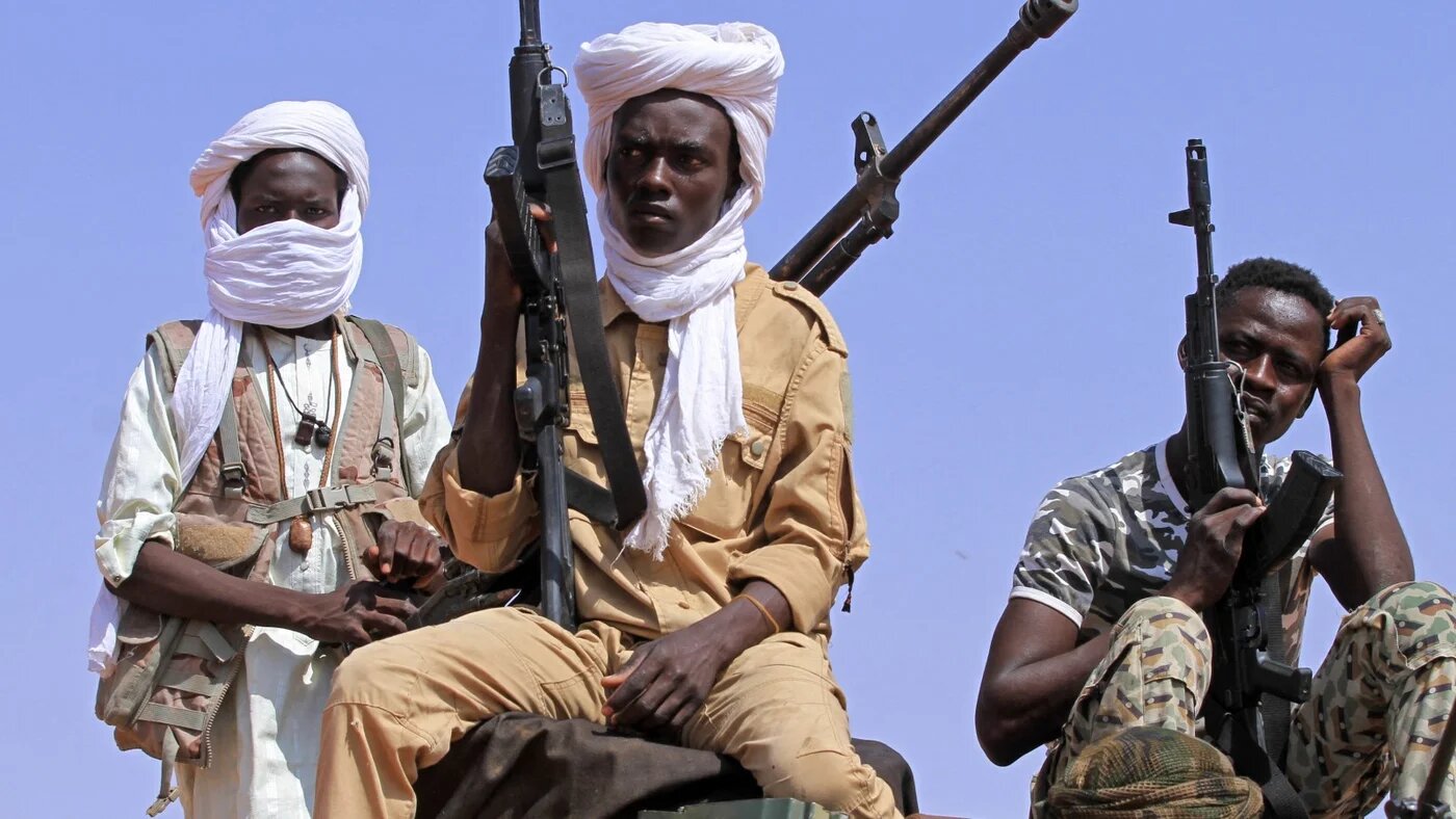 A group of armed defectors from the paramilitary Rapid Support Forces (RSF) arrive in vehicles as they are believed to be surrendering to the Sudanese military, in the west of Omdurman on August 19, 2026. Since April 2023, Sudan has been ravaged by a war between the Sudanese military, led by its chief Abdel Fattah al-Burhan, and the paramilitary Rapid Support Forces, commanded by Burhan's former deputy Mohamed Hamdan Daglo.
