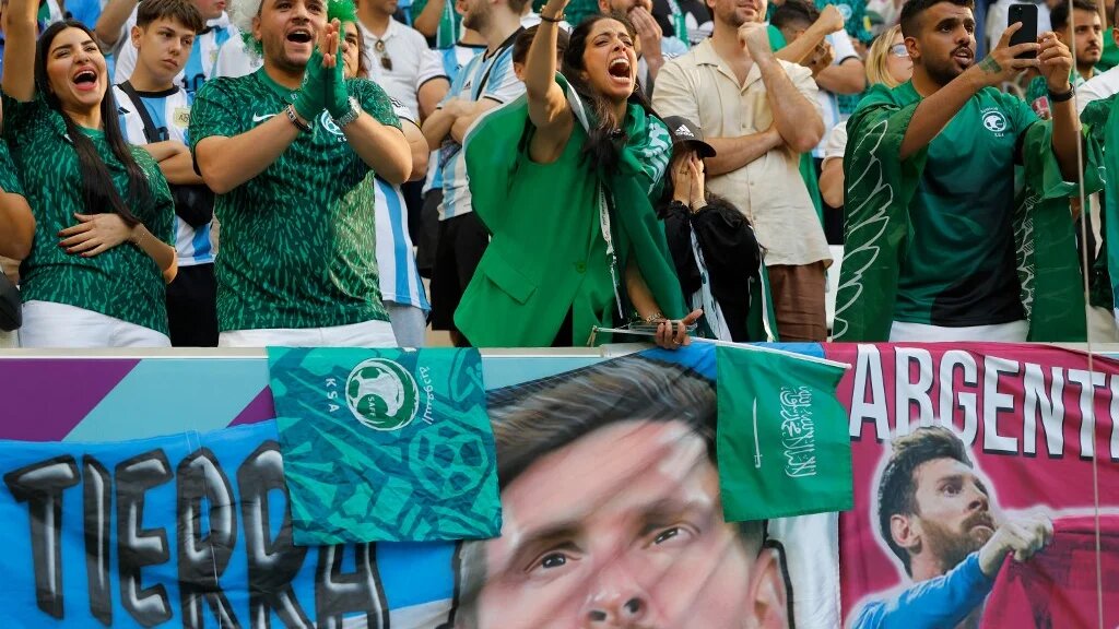 Saudi Arabia fans celebrate their team's victory during the Qatar 2022 World Cup Group C match between Argentina and Saudi Arabia at the Lusail Stadium, north of Doha, on 22 November 2022 (AFP)