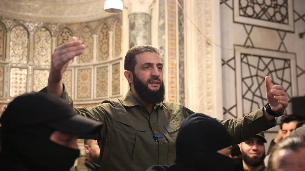 Ahmed al-Sharaa, leader of Syria’s Hay’at Tahrir al-Sham (HTS), addresses a crowd at the Umayyad Mosque in Damascus on 8 December 2024 (AFP/Aref Tammawi)