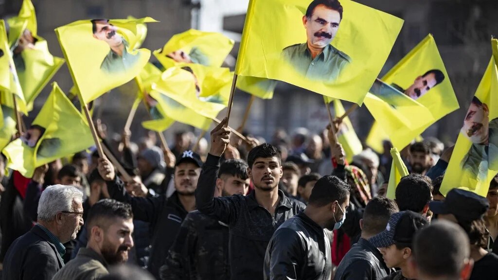 File Photo: Protesters march with yellow flags showing the face of Abdullah Ocalan, the leader of the Kurdistan Worker's Party (PKK) -- currently prison in Turkey, during a demonstration Qamishli in northeastern Syria on December 6, 2022. (Delil SOULEIMAN / AFP)