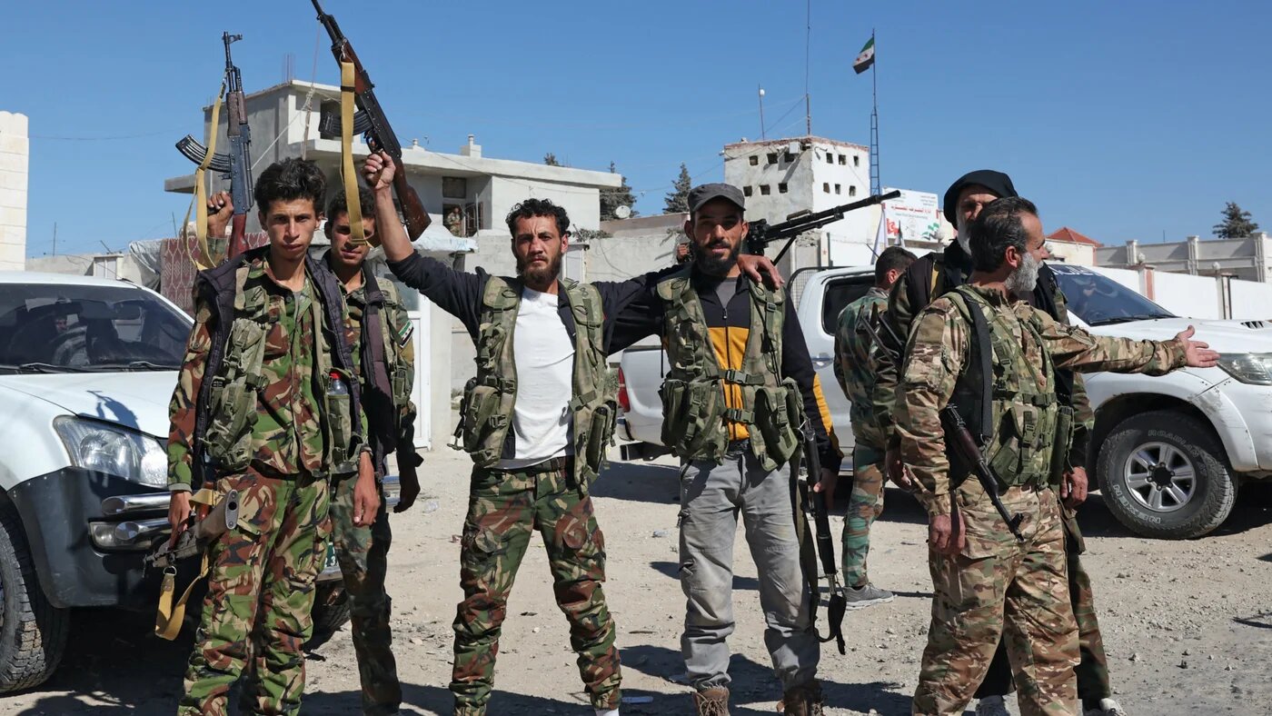 Fighters from the Turkish-backed Free Syrian Army are deployed on a checkpoint in the area of Kafr Jannah on the outskirts of the Syrian town of Afrin on 19 October 2022 (AFP)