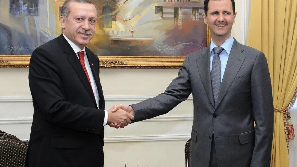 Syrian President Bashar al-Assad (R) shaking hands with Turkish Prime Minister Recep Tayyip Erdogan during a meeting in Aleppo, Syria, on 6 February 2011 (AFP)