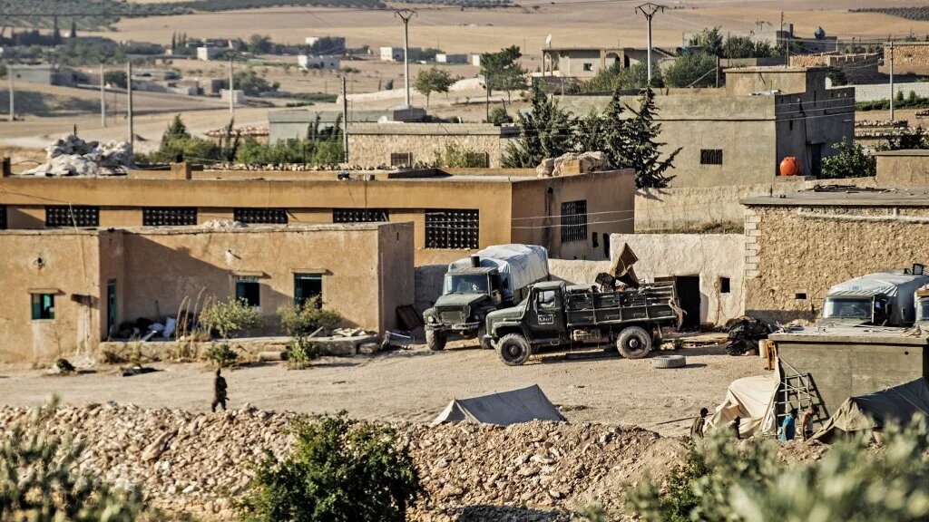 Syrian government forces are seen in Syria's northern city of Manbij, located near the border with Turkey, on 21 July 2022 (AFP)