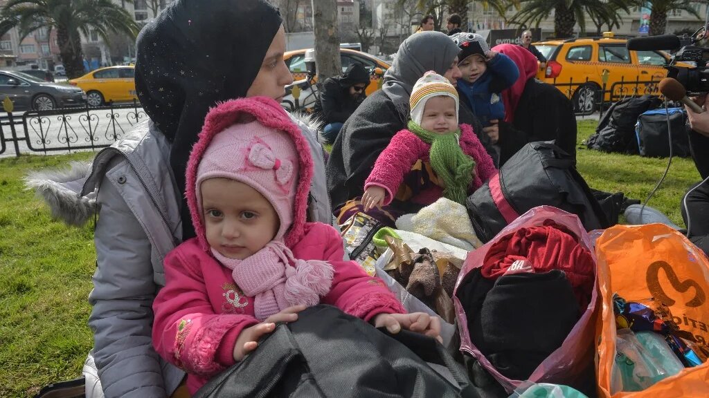 Syrian refugees wait to board a bus in Istanbul, as they head to the border villages in Edirne province on 28 February 2020 (AFP)