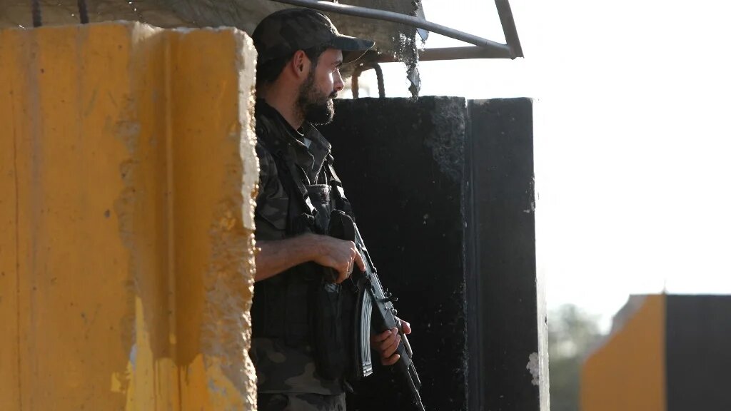 A fighter in a faction of the Turkey-backed Syrian National Army mans a checkpoint in the Tal Battal area near al-Bab city on 26 September 2023 (Bakr Alkasem/AFP)