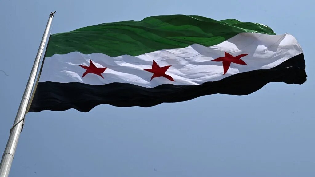 A large Syrian flag flutters above Tishreen Park in Damascus on 4 June 2025 (Louai Beshara/AFP)