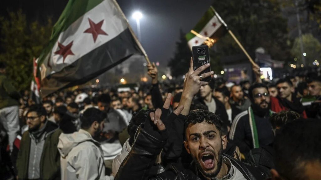 Syrian residents in Gaziantep, Turkey, celebrate the fall of Syrian President Bashar al-Assad, 8 December 2024 (Ozan Kose/AFP)