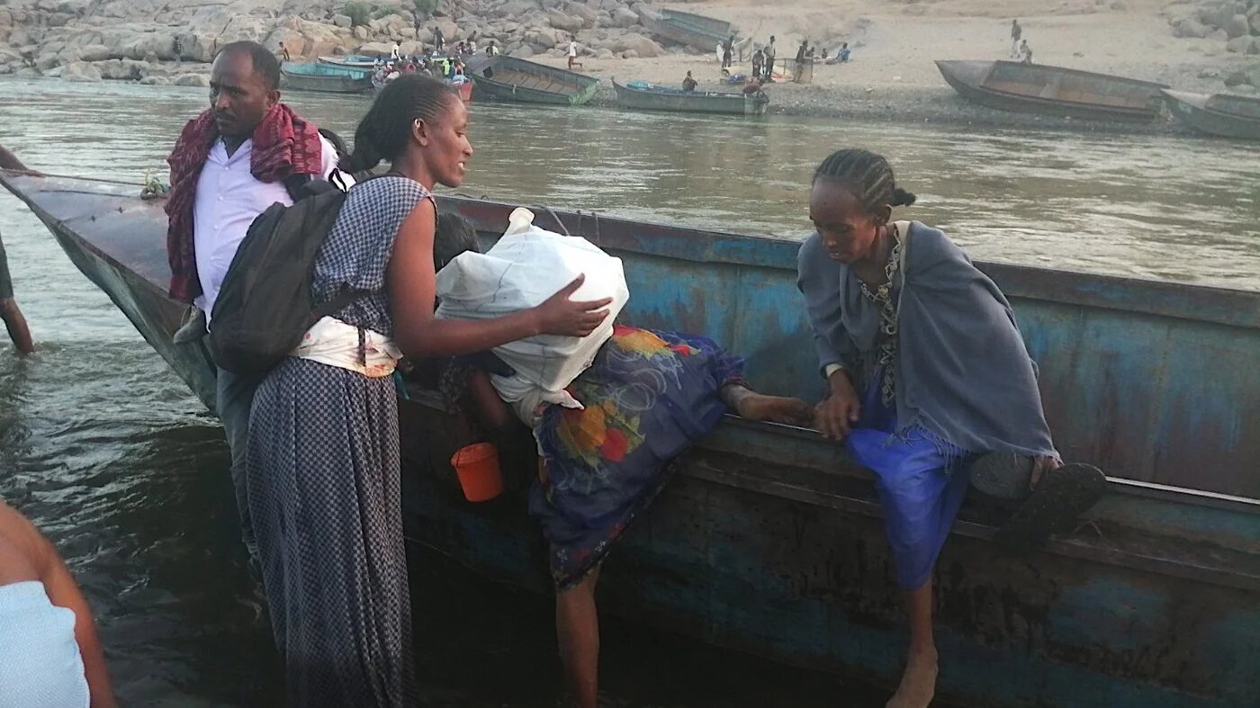 Ethiopian refugees arrive by boat into Sudan