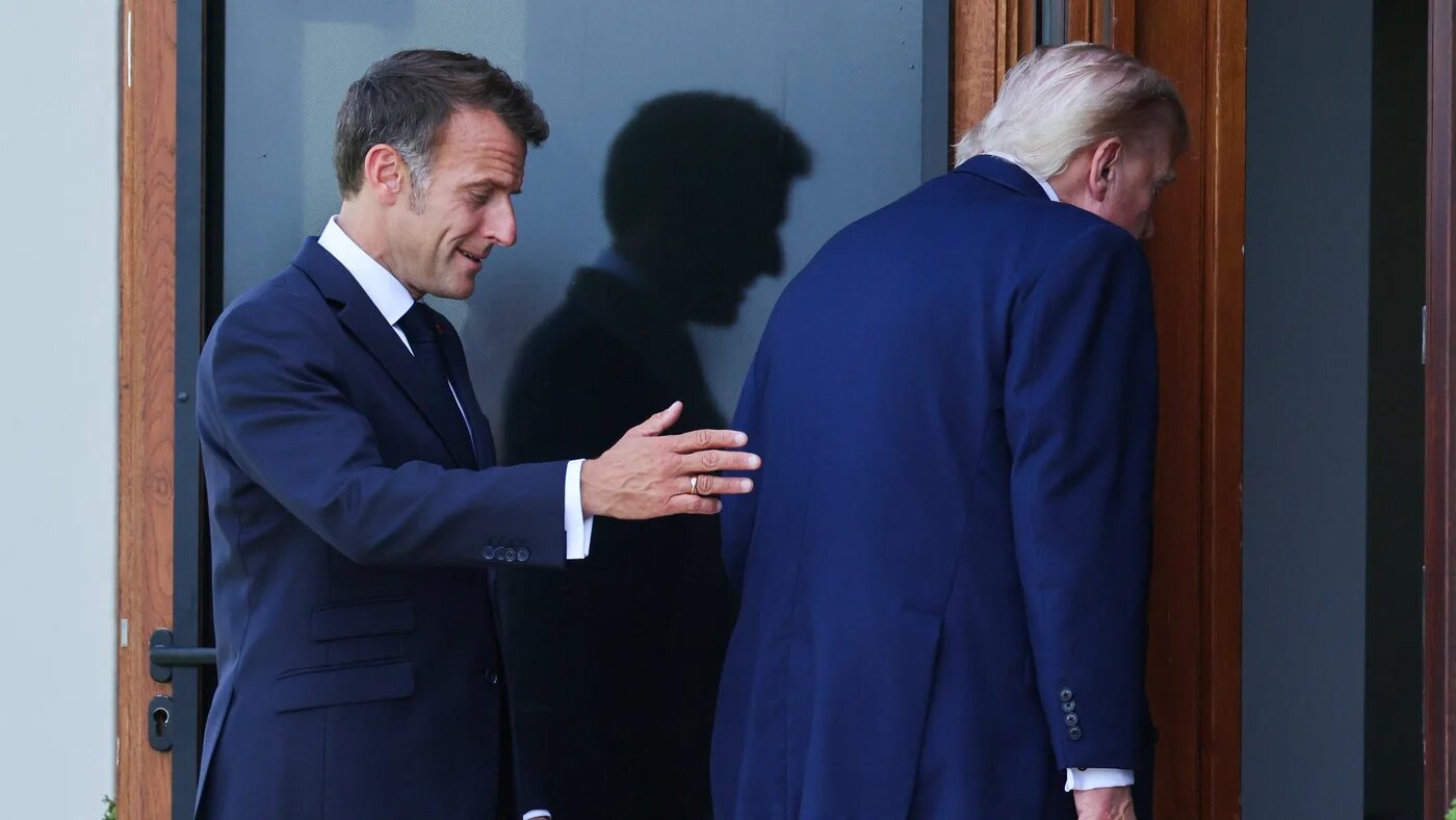French President Emmanuel Macron and US President Donald Trump leave after a family photograph during the G7 summit in Evian on 16 June (AFP)