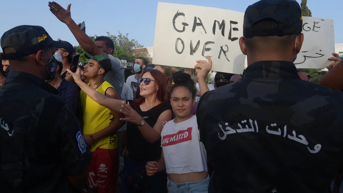 Supporters of Tunisian President Kais Saied chant slogans denouncing Ennahda party leader Rached Ghannouchi in front of the Parliament in the capital Tunis on 26 July 2021.