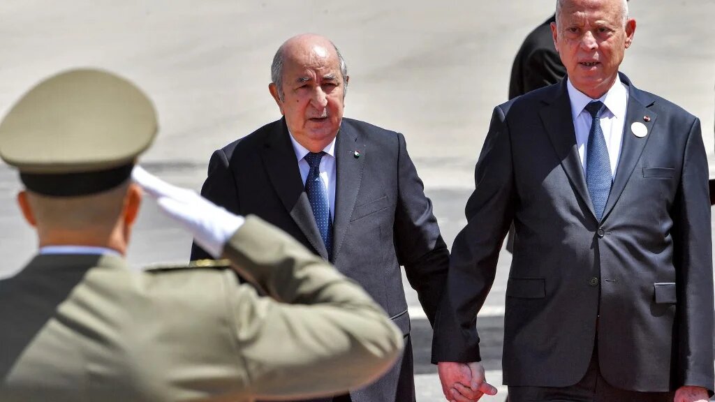 Tunisia's President Kais Saied (right) receives Algeria's President Abdelmadjid Tebboune upon the latter's arrival at Tunis-Carthage International Airport in April 2024 (Fethi Belaid/AFP)