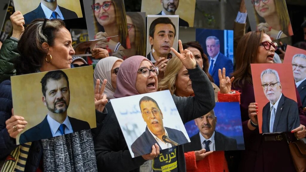 Relatives of detainees accused of involvement in a conspiracy case against state security demonstrate in front of a Tunis court on 4 March (Fethi Balaid/AFP)