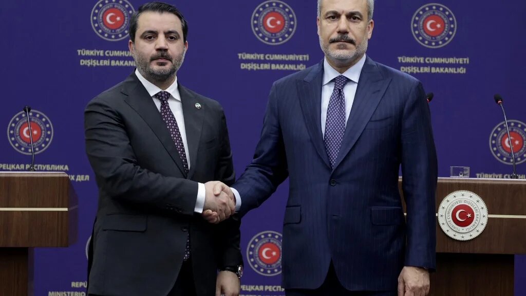 Syria's Foreign Minister Asaad al-Shaibani (L) and Turkey's Foreign Minister Hakan Fidan (R) shake hands following their joint press conference in Ankara on January 15, 2025. (Adem ALTAN / AFP)
