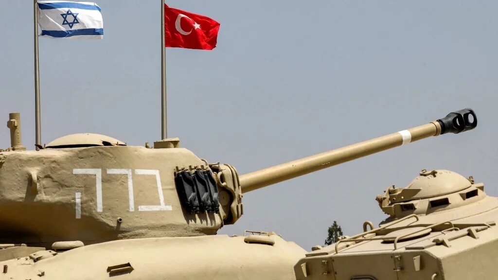 The flags of (L to R) Israel and Turkey fly behind M4A1 Sherman and AMX-13 battle tanks on display at the Yad La-Shiryon Tank Museum in Latrun, about 30 kilometres west of Jerusalem, on August 18, 2022.  (AFP)