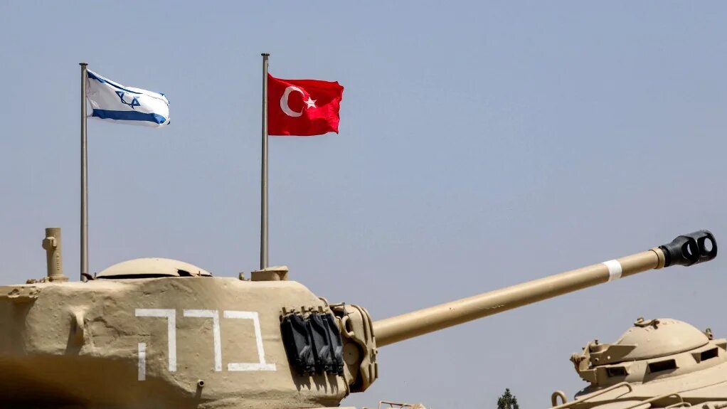The flags of (L to R) Israel and Turkey fly behind M4A1 Sherman and AMX-13 battle tanks on display at the Yad La-Shiryon Tank Museum in Latrun, about 30 kilometres west of Jerusalem, on August 18, 2022.  (GIL COHEN-MAGEN / AFP)