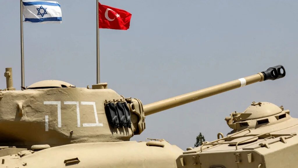 The flags of (L to R) Israel and Turkey fly behind M4A1 Sherman and AMX-13 battle tanks at the Yad La-Shiryon Tank Museum in Latrun, about 30 kilometres west of Jerusalem, on August 18 2022.  (Gil Cohen-Magen / AFP)
