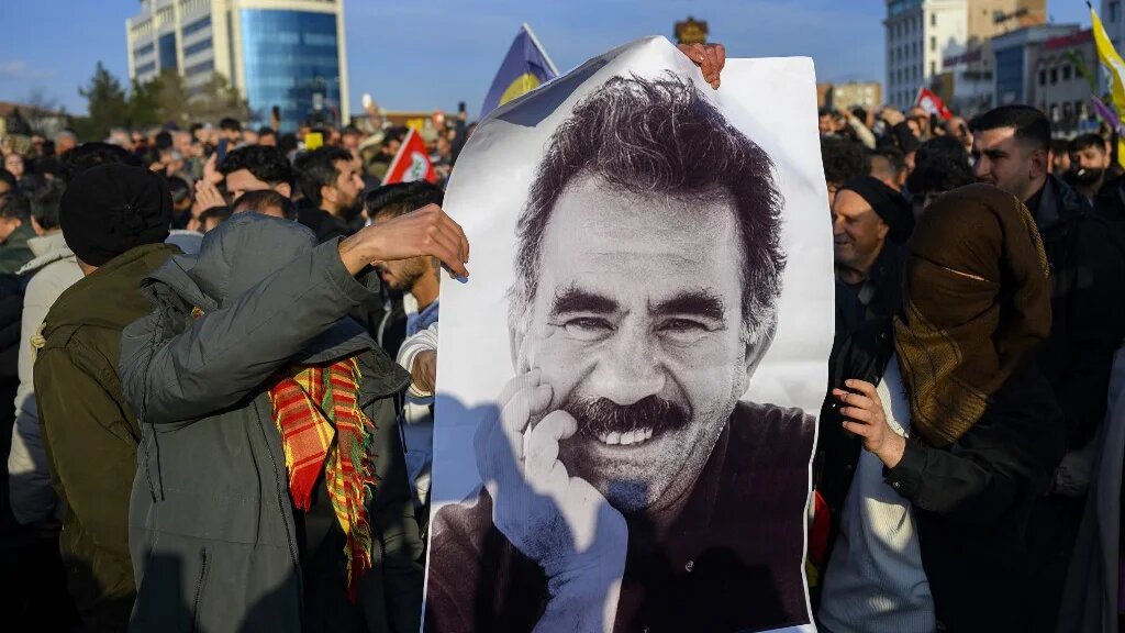 Supporters display a poster depicting jailed leader of the Kurdistan Workers' Party (PKK) Abdullah Ocalan, 75, on February 27, 2025 in Istanbul. (Yasin AKGUL / AFP)