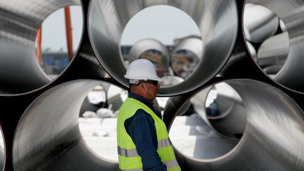 A worker stands next to newly arrived pipes for the construction of the future Trans-Adriatic Pipeline in Spitalle, near Durres on April 18, 2016, aimed to bring gas from the Caspian Sea to Europe. (AFP)