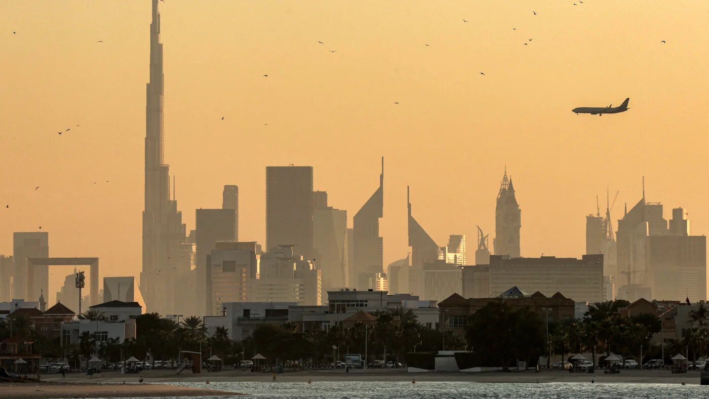 A photo of Dubai skyline with Burj Khalifa and an airplane in February 2024. AFP/Giuseppe Cacace.