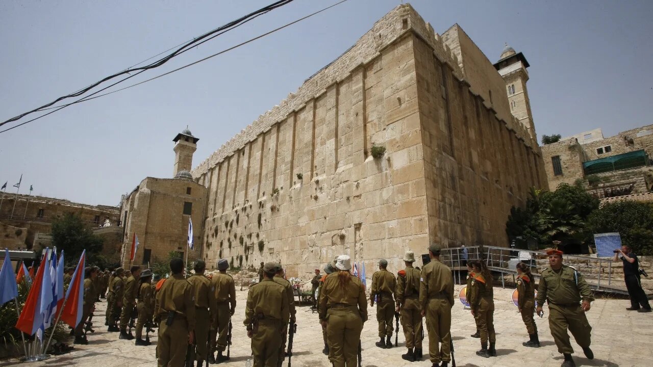 Israeli soldiers stand outside the Tomb of the Patriarchs, also known as the Ibrahimi Mosque