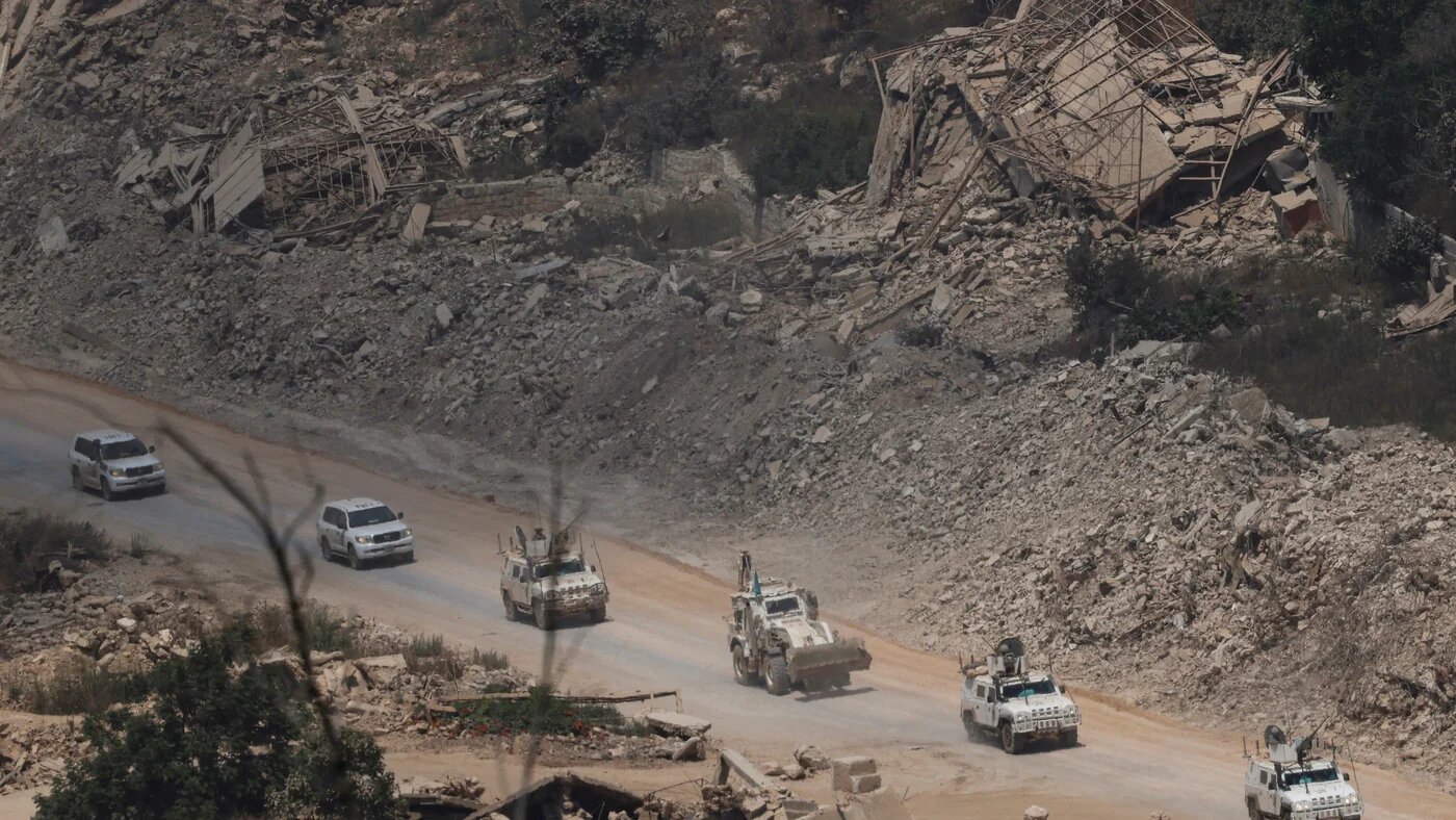 United Nations Interim Force in Lebanon (UNIFIL) armoured vehicles driving past destroyed buildings in southern Lebanon on 22 July 2026 (Jalaa Marey/AFP)