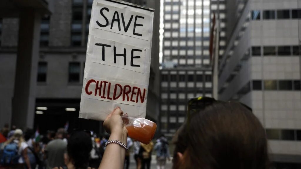 A demonstrator holds up a sign during a rally against the conflict in Gaza and the occupied West Bank on 2 September in New York City (John Lamparski/AFP) 