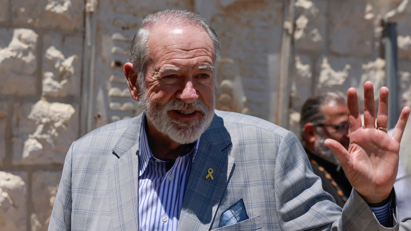 Mike Huckabee visits the Israeli-occupied Palestinian village of Taybeh in the West Bank in July 2025 (AFP)