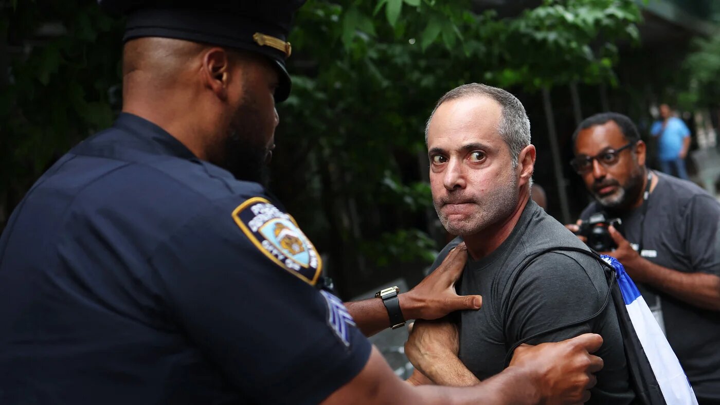 A New York Police officer holds back a pro-Israel protester during a pro-Palestine rally at Baruch College in New York City, on 5 June 2025 (Michael M Santiago/AFP) 