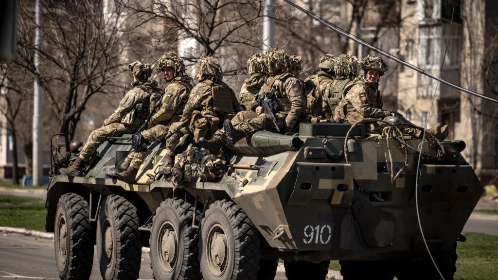 Ukrainian soldiers ride on a armoured military vehicle in the city of Severodonetsk, Donbas region, 7 April 2022 (AFP)