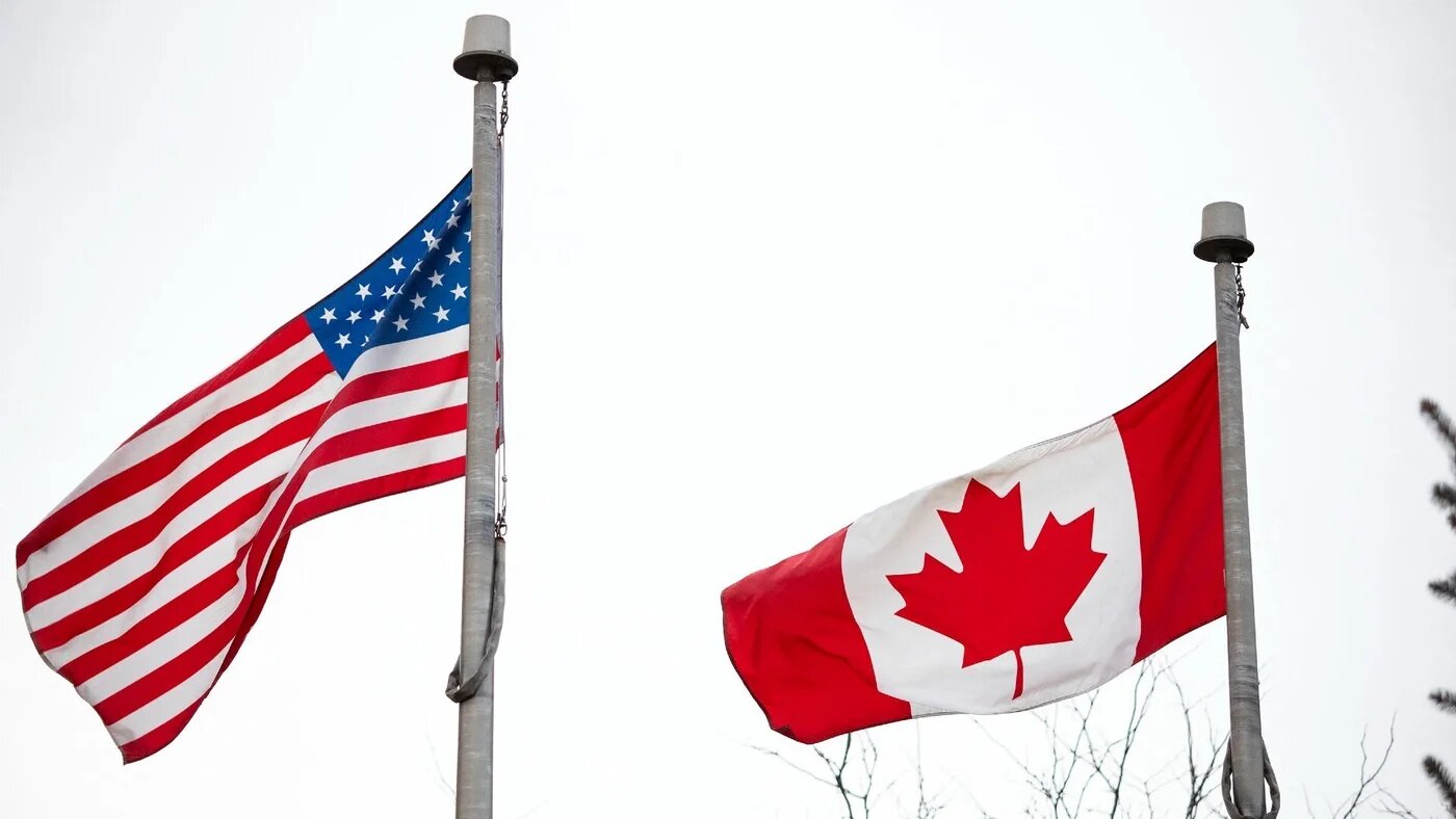 Flags of the United States and Canada fly at a Customs station at the Ambassador Bridge on 4 March 2025 in Windsor, Canada (AFP)