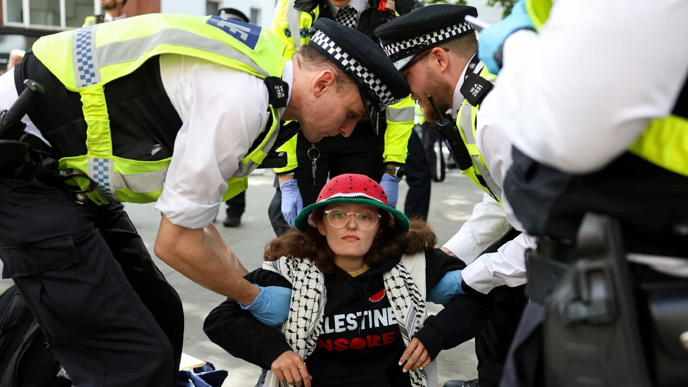 Police officers detain a demonstrator opposing the government's decision to ban Palestine Action as a terror organisation, following a Court of Appeal ruling on the lawfulness of proscribing the pro-Palestinian group under terrorism laws, outside the Royal Courts Of Justice, in London, 15 June 2026 (Reuters)