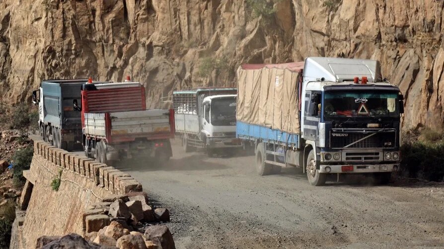 Trucks on a heavily damaged road between Yemen's cities of Taiz and Aden, 23 September 2020 (AFP)