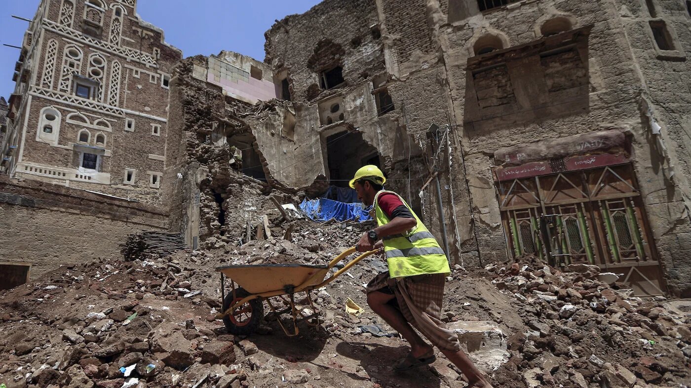 Worker repairs home in Old City of Sanaa