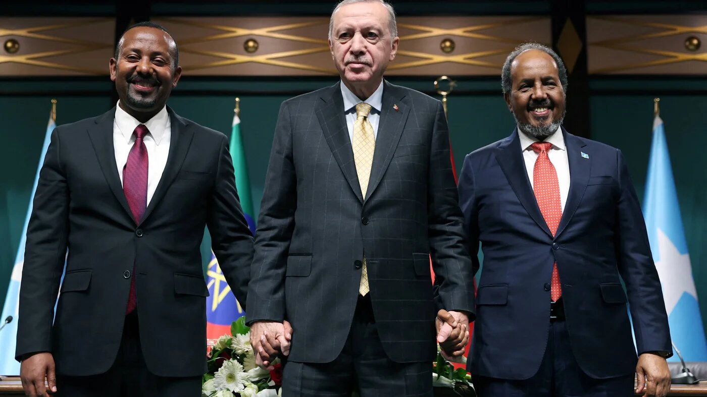 Ethiopian Prime Minister Abiy Ahmed (left), Turkish President Recep Tayyip Erdogan (centre) and Somali President Hassan Sheikh Mohamud pose after signing the Ankara Declaration on 11 December in Ankara (Turkish Presidency/Handout)