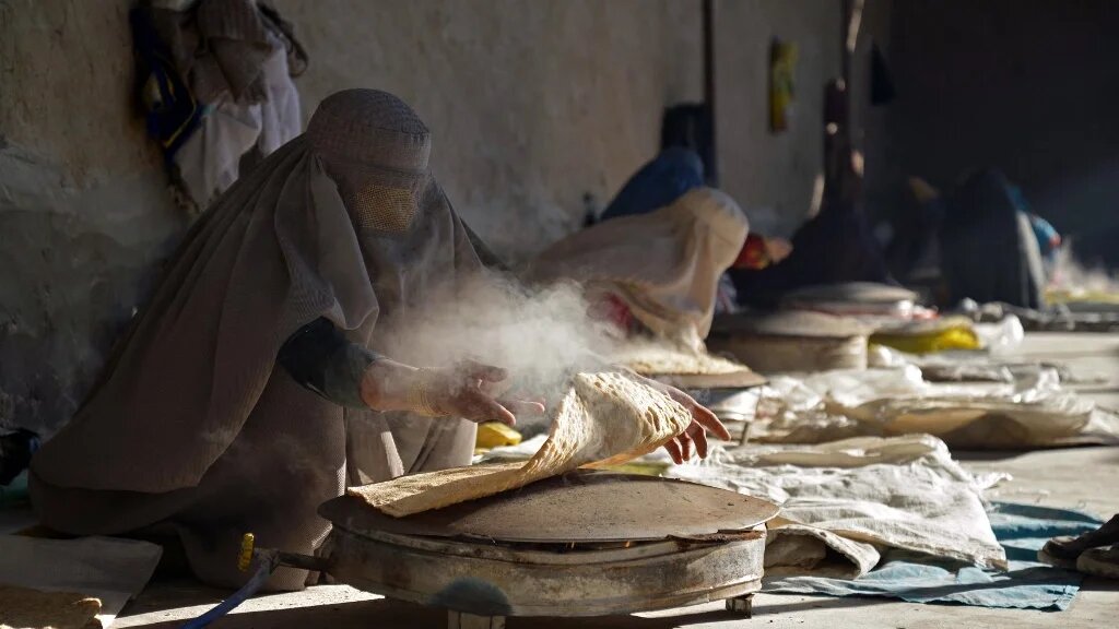 Afghan women workers prepare bread at a workplace to sell in a market in Kandahar on January 5, 2023. (AFP)