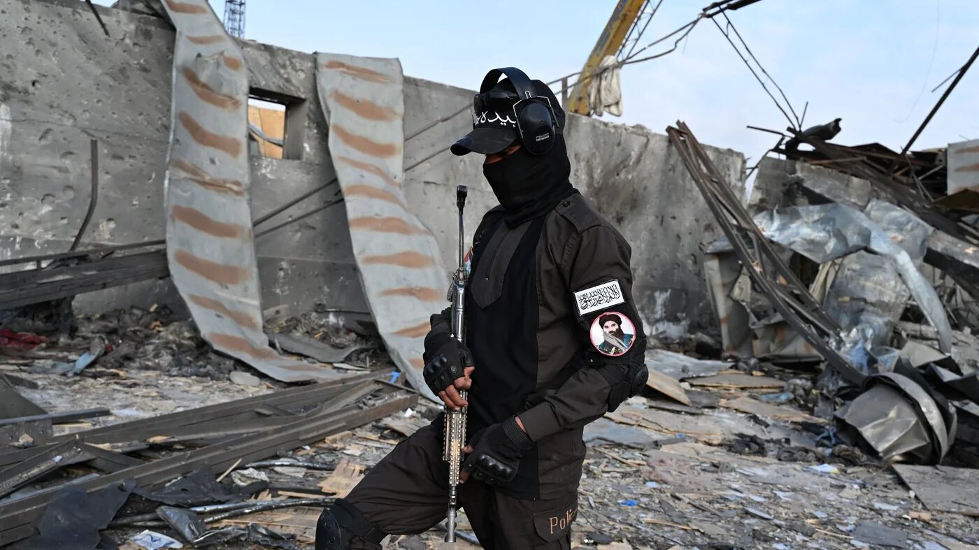 A Taliban security officer patrols the site of a Pakistani attack on Kabul on 17 March (AFP/Wakil Kohsar)