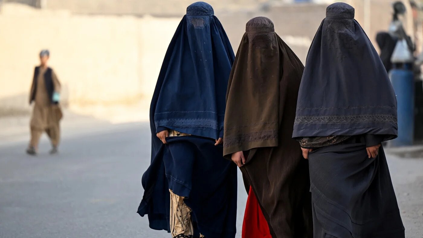 Afghan burqa-clad women walk along a street in the Dand district of Afghanistan's Kandahar province on October 5, 2026. Sanaullah SEIAM / AFP