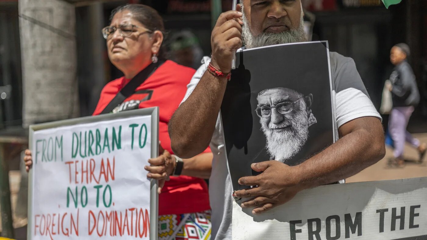 A protester holds a portrait of Iran's late supreme leader Ayatollah Ali Khamenei while gathering during a solidarity protest outside the US Consulate in Durban on 3 March 2026 (Rajesh Jantilal/AFP)