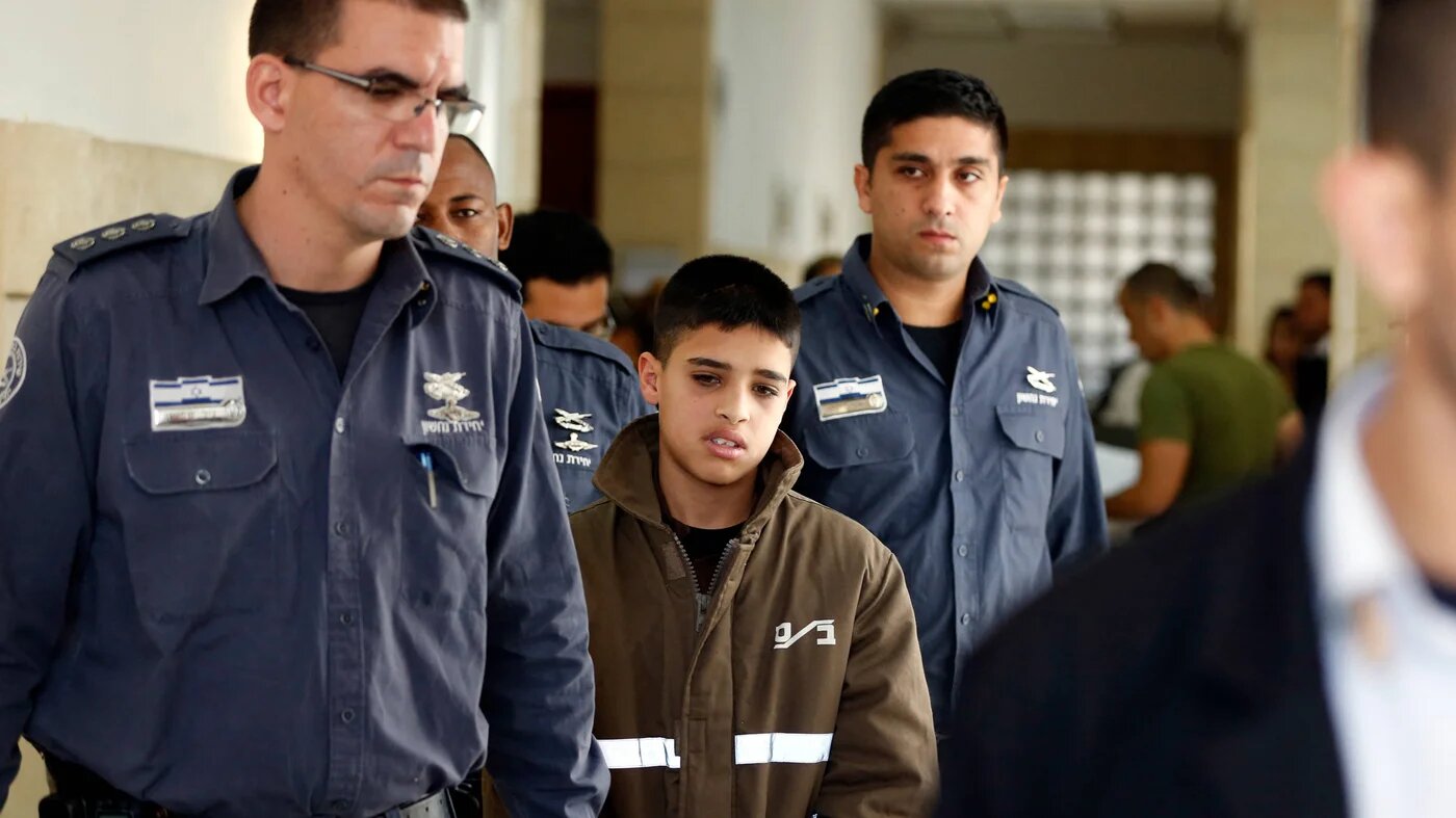Ahmed Manasra, then aged 13, escorted by Israeli security during a hearing at a Jerusalem court on 30 October 2015 (AFP/Ahmad Gharabli) 
